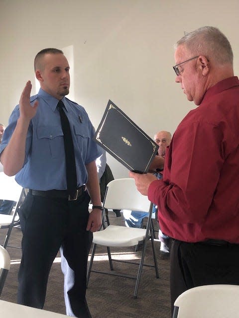 Bedford Mayor Sam Craig swears in B. Garrett Scherschel, as a new member of the Bedford Fire Department Monday during a meeting of the Bedford Board of Works and Safety.