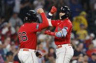 Boston Red Sox's Trevor Story, right, celebrates his two-run home run that scored Triston Casas (36) against the Los Angeles Dogers during the second inning of a baseball game Friday, Aug. 25, 2023, in Boston. (AP Photo/Michael Dwyer)