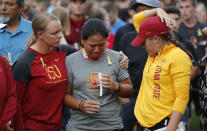 Iowa State golf team members react during a vigil for slain teammate Celia Barquin Arozamena, Wednesday, Sept. 19, 2018, in Ames, Iowa. Barquin, who was the 2018 Big 12 women's golf champion and Iowa State Female Athlete of the Year, was found Monday morning in a pond at a golf course near the Iowa State campus. (AP Photo/Charlie Neibergall)