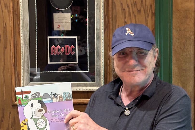 ACDC's Brian Johnson with the book that he has narrated, 'Bobby's Big Day Out'.