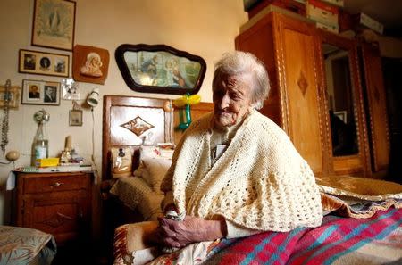 Emma Morano, thought to be the world's oldest person and the last to be born in the 1800s, sits on her bed during her 117th birthday in Verbania, northern Italy November 29, 2016. REUTERS/Alessandro Garofalo/Files