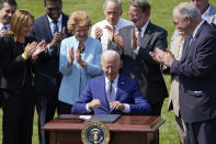 President Joe Biden signs an executive order on increasing production of electric vehicles after speaking on the South Lawn of the White House in Washington, Thursday, Aug. 5, 2021, during an event on clean cars and trucks. (AP Photo/Susan Walsh)