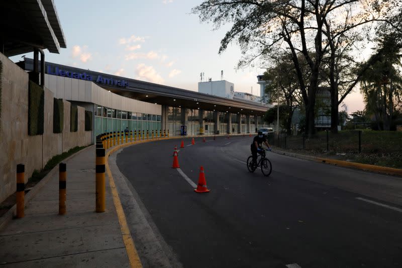 A policeman rides a bicycle after El Salvador's President Bukele ordered the closing of the airport in San Luis Talpa