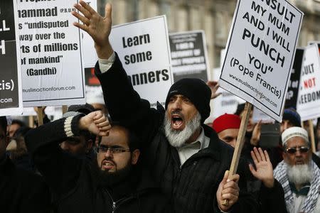 Muslim demonstrators hold placards during a protest against the publication of cartoons depicting the Prophet Mohammad in French satirical weekly Charlie Hebdo, near Downing Street in central London February 8, 2015. REUTERS/Stefan Wermuth