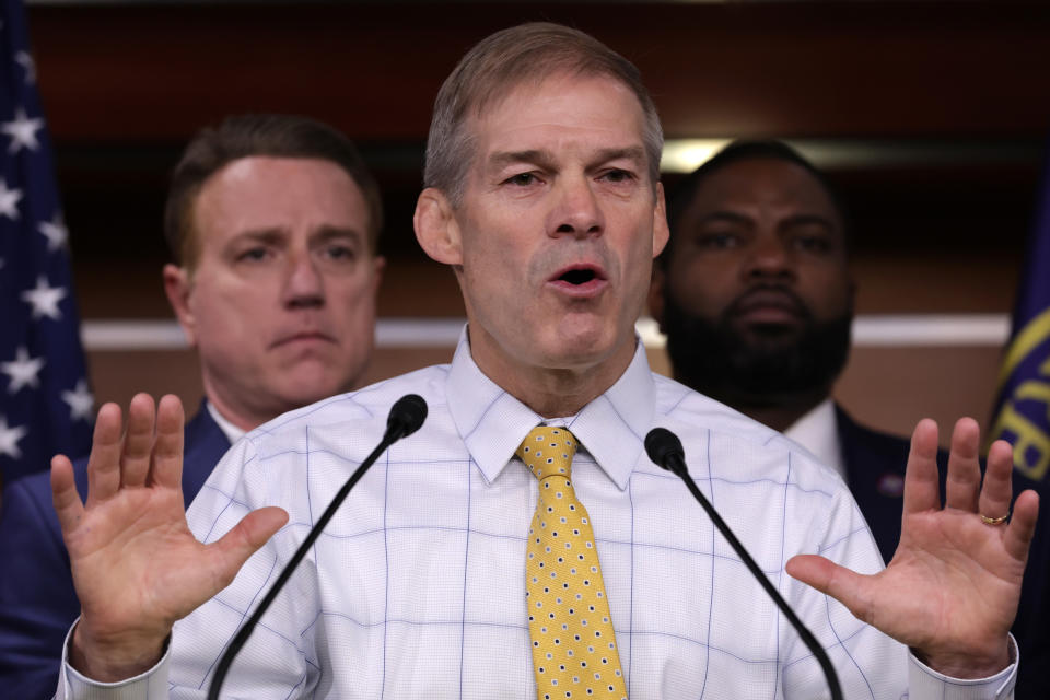 Flanked by House Republicans, Rep. Jim Jordan speaks at a news conference.