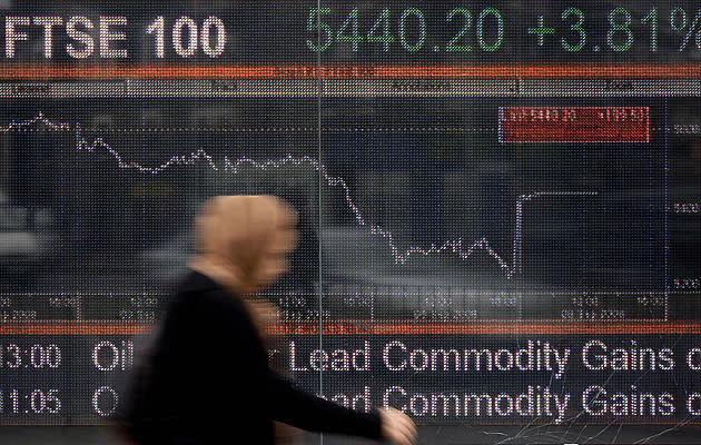 A large computerised display of the British FTSE 100 index shows the figure flat-lining. Despite the overall fall, travel stocks advanced and capped losses for the index (SHAUN CURRY/AFP/Getty Images)