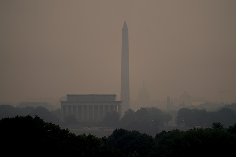 Haze blankets over monuments on the National Mall in Washington, Wednesday, June 7, 2023, as seen from Arlington, Va. (AP Photo/Julio Cortez)