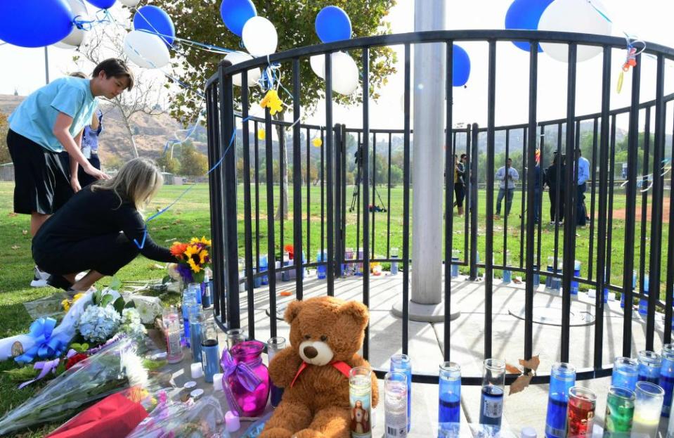 Flowers are dropped off at a makeshift memorial not far from the school.