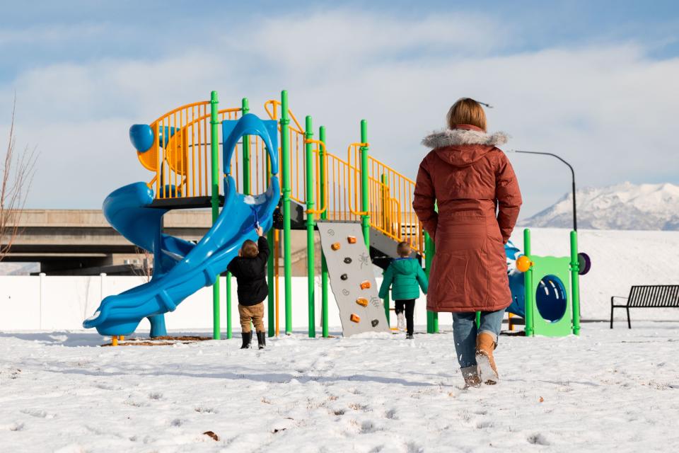 Lauren Hess watches as her children play at the park by their home in Syracuse on Saturday, Jan. 6, 2024. Hess has worked to make her home cozy and to appreciate unique aspects of the season in an effort to boost her mood during the winter. | Megan Nielsen, Deseret News