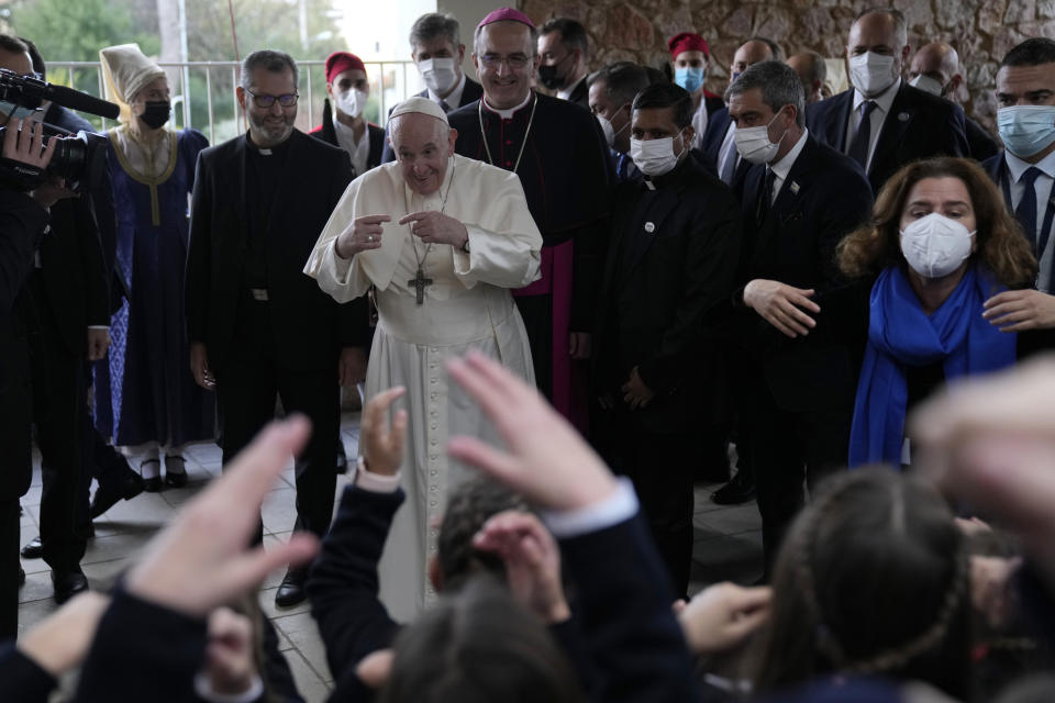 Pope Francis visits Saint Dionysius School of the Ursuline Sisters in Athens, Greece, Monday, Dec. 6, 2021. Francis' five-day trip to Cyprus and Greece has been dominated by the migrant issue and Francis' call for European countries to stop building walls, stoking fears and shutting out "those in greater need who knock at our door." (AP Photo/Thanassis Stavrakis, Pool)