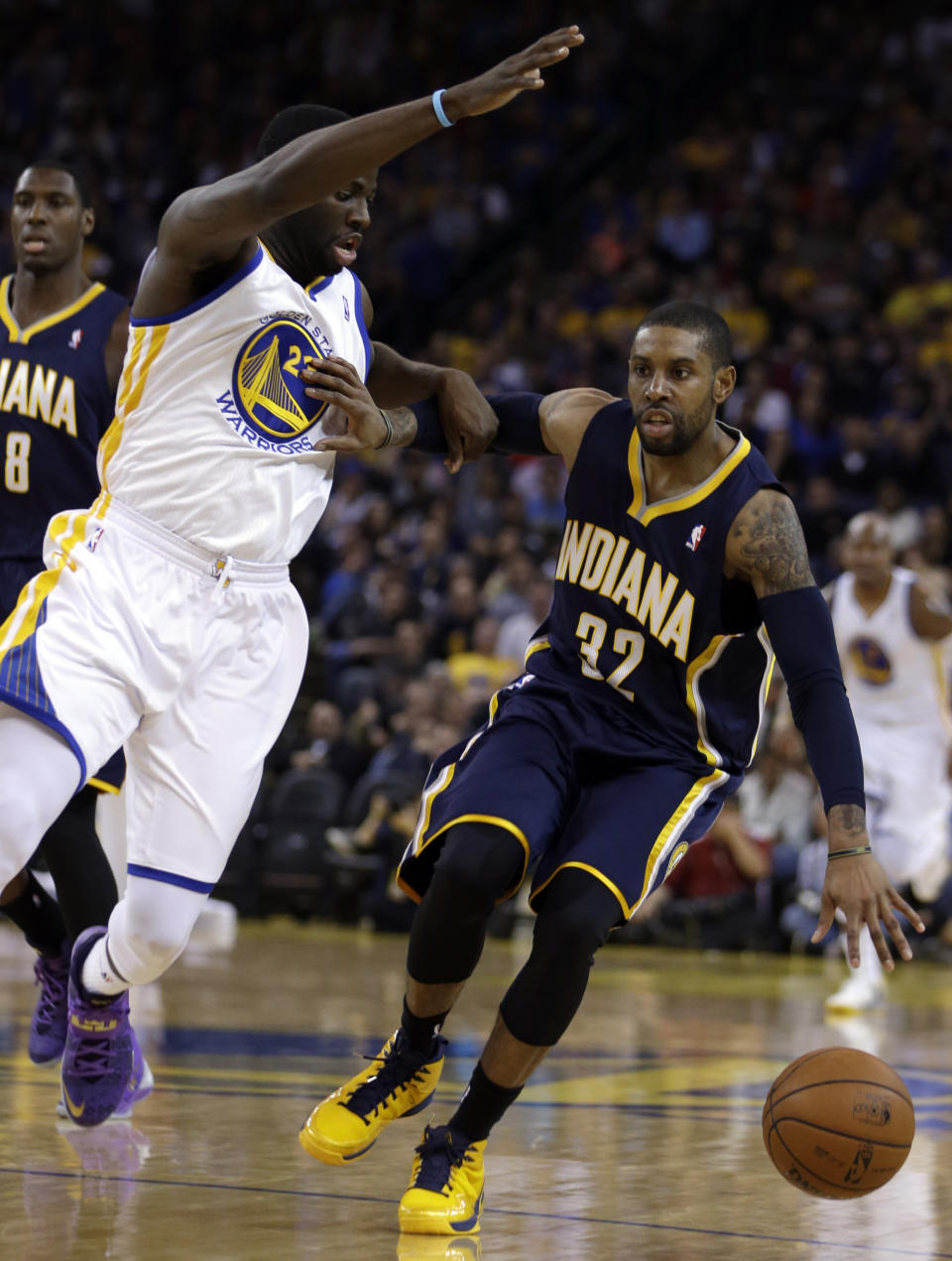 Indiana Pacers' C.J. Watson, right, drives the ball against Golden State Warriors' Draymond Green during the first half of an NBA basketball game, Monday, Jan. 20, 2014, in Oakland, Calif. (AP Photo/Ben Margot)