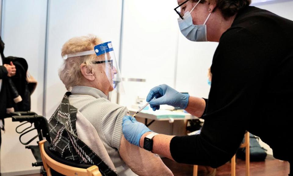 A woman receives the coronavirus vaccine in Aalborg, Denmark, on Monday