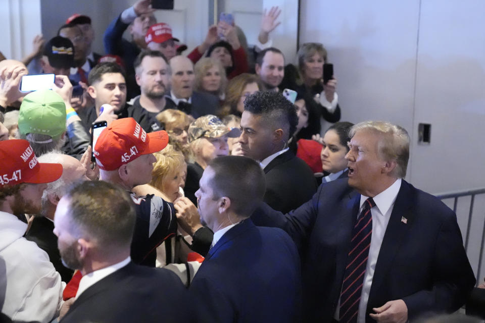 Republican presidential candidate former President Donald Trump greets supporters at a primary election night party in Nashua, N.H., Tuesday, Jan. 23, 2024. (AP Photo/Matt Rourke)