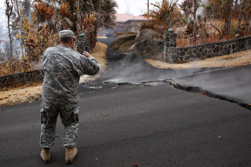 Major Jeff Hickman, of the Hawaii National Guard, takes a photo in the Leilani Estates subdivision on May 13, 2018.&nbsp;