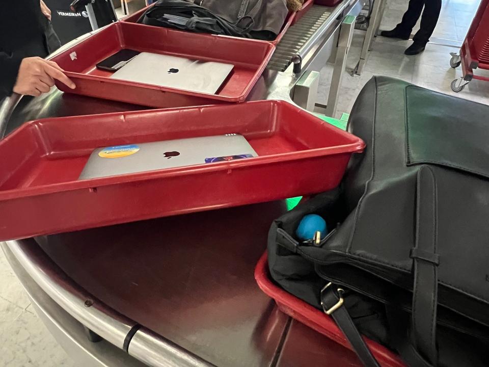 Flying on La Compagnie all-business class airline from Paris to New York — personal belongings in Orly airport's security lane.