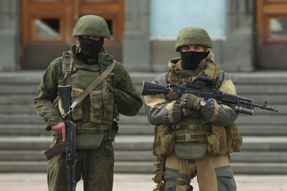 A picture shows soldiers standing outside of a building. 