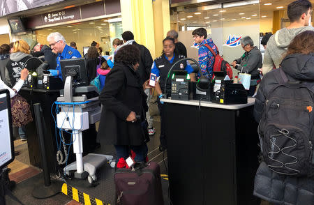 Travelers wait in a security line at Reagan Washington National Airport in Arlington, Virginia, U.S., January 13, 2019. REUTERS/David Shepardson