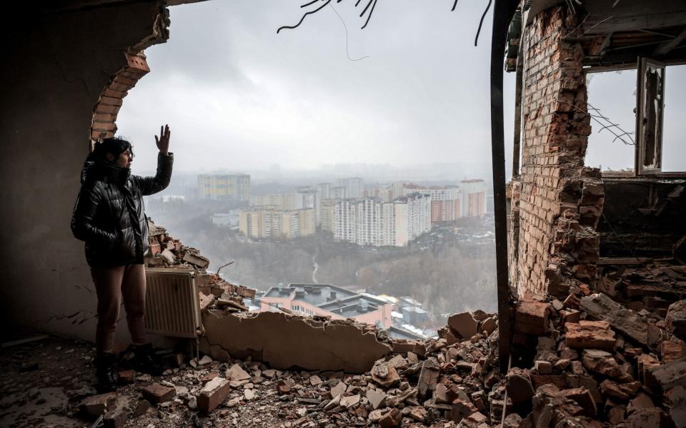 Tetiana, a local resident, inspects her ruined flat at the site of an overnight Russian drone attack on Kyiv