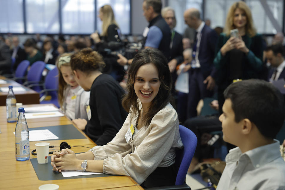 Sofia Oliveira, center, smiles to her brother Andre as they arrive at the European Court of Human Rights, where they are accusing 32 European governments of violating their human rights for what they say is a failure to adequately address climate change, Wednesday, Sept. 27, 2023, in Strasbourg. (AP Photo/Jean-Francois Badias)