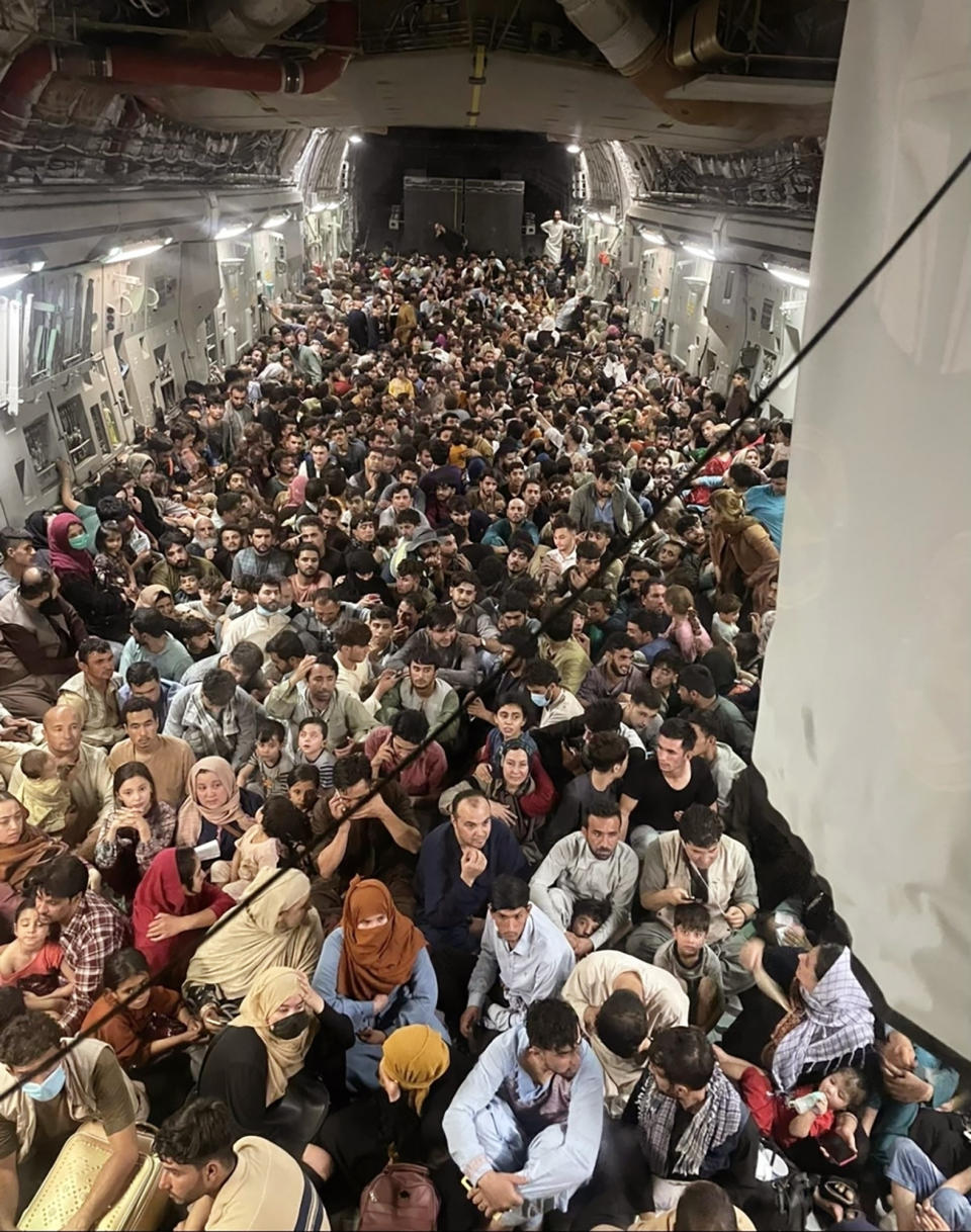 Afghan citizens pack inside a U.S. Air Force C-17 Globemaster III, as they are transported from Hamid Karzai International Airport in Afghanistan, Sunday, Aug. 15, 2021. On Friday, Aug. 20, 2021, The Associated Press reported on stories circulating online incorrectly claiming another photo showed a plane full of Afghan refugees being evacuated from the country this week, with not a single woman or child among them. In fact, that photo, which appeared online as early as 2018, shows Afghan refugees being sent back to their country from Turkey, according to a story at the time from Turkey’s state-run news agency, the Anadolu Agency. Photos captured this week show that hundreds of Afghan men, women and children have been evacuated from Afghanistan since the Taliban takeover. (Capt. Chris Herbert/U.S. Air Force via AP)