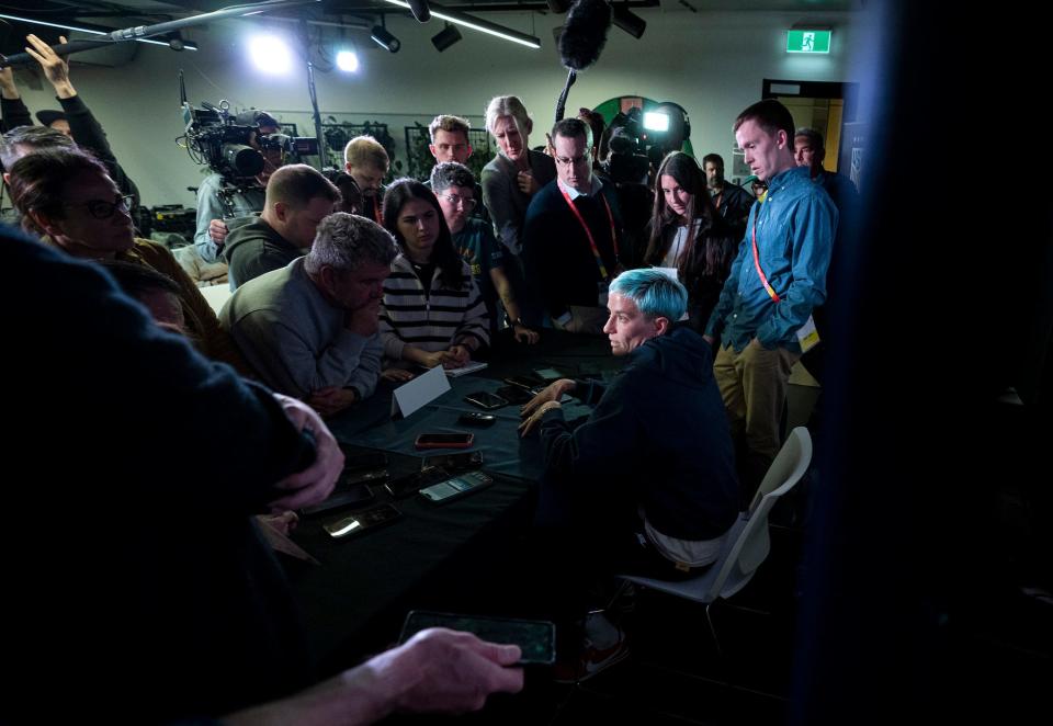 Journalists surround United States forward Megan Rapinoe (15) who answers questions during a U.S. soccer press conference Sunday, July 30, 2023, amid the 2023 FIFA Women's World Cup in Auckland, New Zealand. Just before the tournament, the longtime U.S. team player announced she would retire at the end of the 2023 NWSL season.