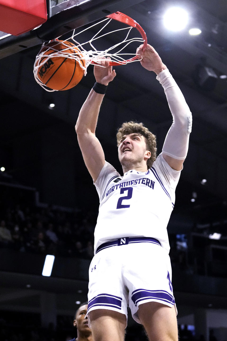 Northwestern forward Nick Martinelli hangs from the rim after dunking during the second half of an NCAA college basketball game against Penn State in Evanston, Ill., Sunday, Feb. 11, 2024. Northwestern won 68-63. (AP Photo/Nam Y. Huh)