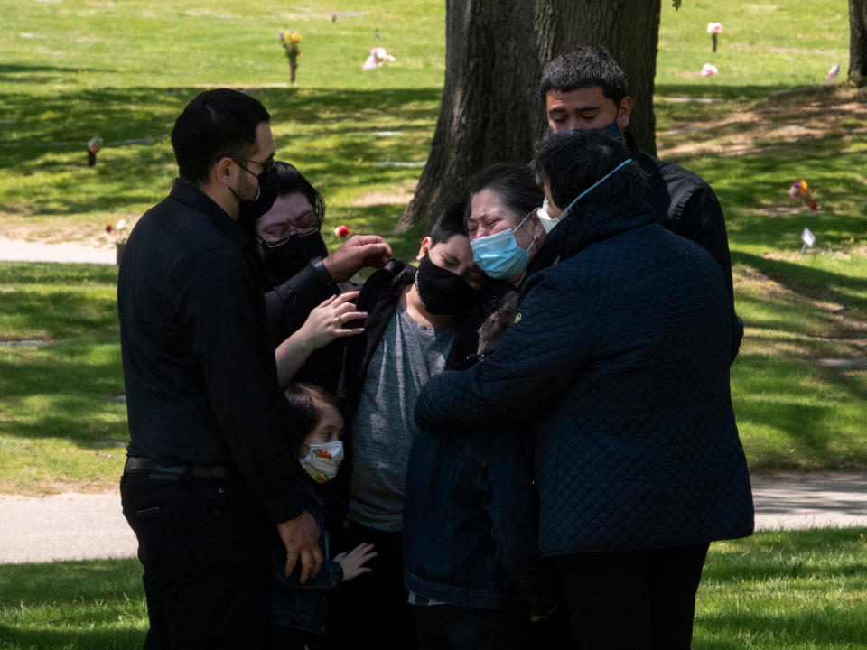 <strong>Queens, N.Y., May 13, 2020.</strong> The family of Salvador Calderon mourns his death from COVID-19 at Maple Grove Cemetery.<span class="copyright">Peter van Agtmael—Magnum Photos</span>