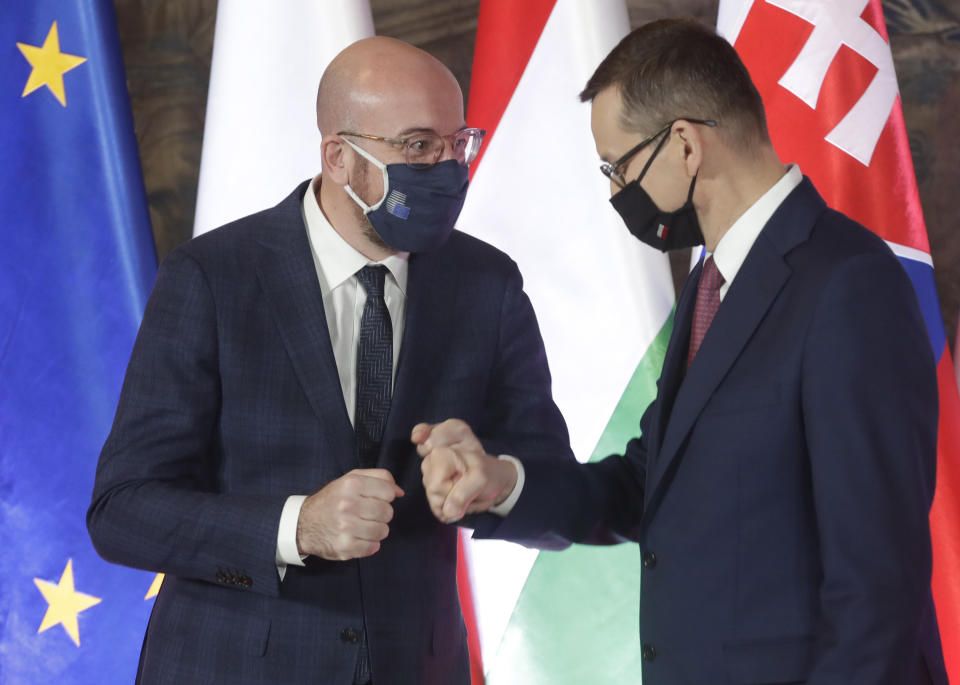 European Council President Charles Michel, left, and Poland's Prime Minister Mateusz Morawiecki during welcoming ceremony ahead of a ceremonious meeting that marks 30 years of central Europe's informal body of cooperation between Poland, Hungary, Slovakia and The Czech Republic, called the Visegrad Group, at the Wawel Castle in Krakow, Poland, Wednesday, Feb. 17, 2021.(AP Photo/Czarek Sokolowski)