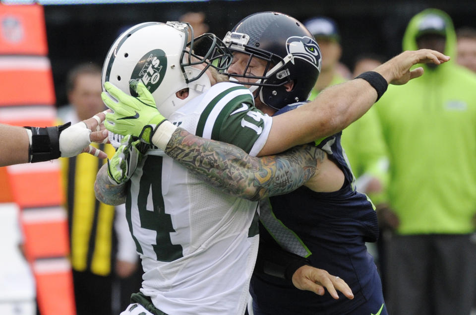 Seattle Seahawks defensive end Cassius Marsh hits New York Jets' Ryan Fitzpatrick, left. (AP)