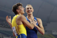 Armand Duplantis, left, of Sweden, and Sam Kendricks, right, of the United States, congratulate one another after the the men's pole vault final at the World Athletics Championships in Doha, Qatar, Tuesday, Oct. 1, 2019. (AP Photo/Hassan Ammar)