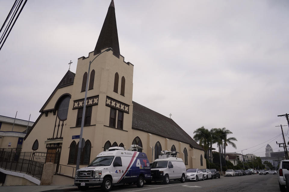 FILE - News media vans are parked outside St. Anthony Croatian Catholic Church in Los Angeles on Wednesday, June 14, 2023. A bus carrying migrants from a Texas border city arrived in downtown Los Angeles on Saturday, July 1, for the second time in less than three weeks. The group of asylum seekers from Brownsville, Texas, were hosted and processed at the church, according to the Coalition for Humane Immigrant Rights of Los Angeles (CHIRLA), the largest immigrant rights organization in California. (AP Photo/Damian Dovarganes, File)