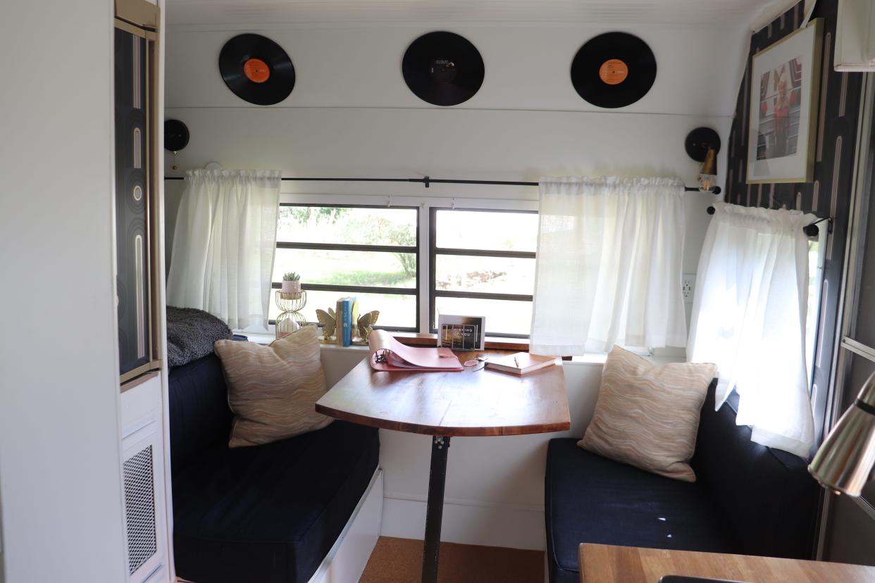 The interior of an RV decorated with Dolly Parton photos and records