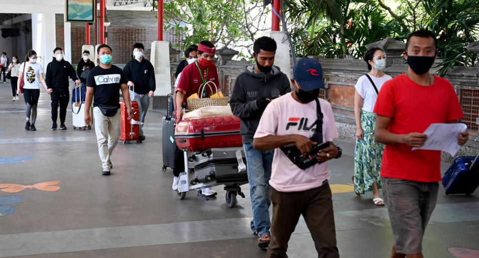 People walking out of Denpasar airport, Bali. 