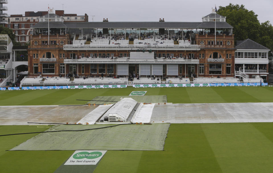 Rain covers protect the wicket as rain delays play after lunch on day three of the 2nd Ashes Test cricket match between England and Australia at Lord's cricket ground in London, Friday, Aug. 16, 2019. (AP Photo/Alastair Grant)