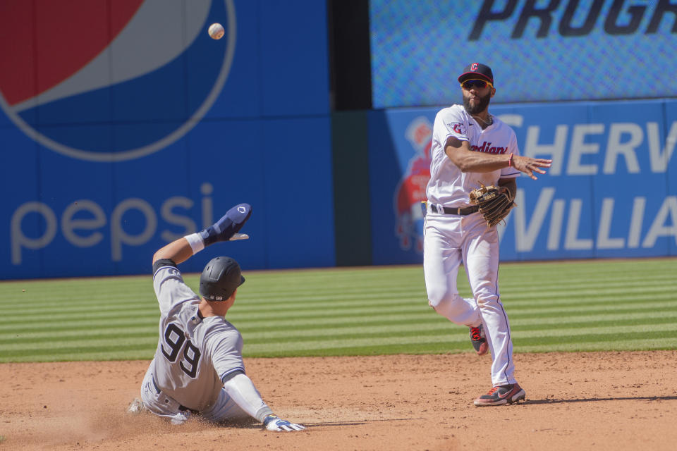 Cleveland Guardians' Amed Rosario forces Aaron Judge at second base and throws out Anthony Rizzo at first for a double play during the sixth inning of a baseball game in Cleveland, Wednesday April 12, 2023. (AP Photo/Phil Long)