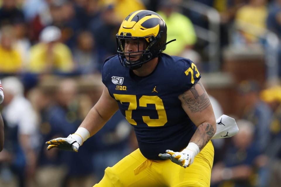 Michigan offensive lineman Jalen Mayfield blocks during a game.