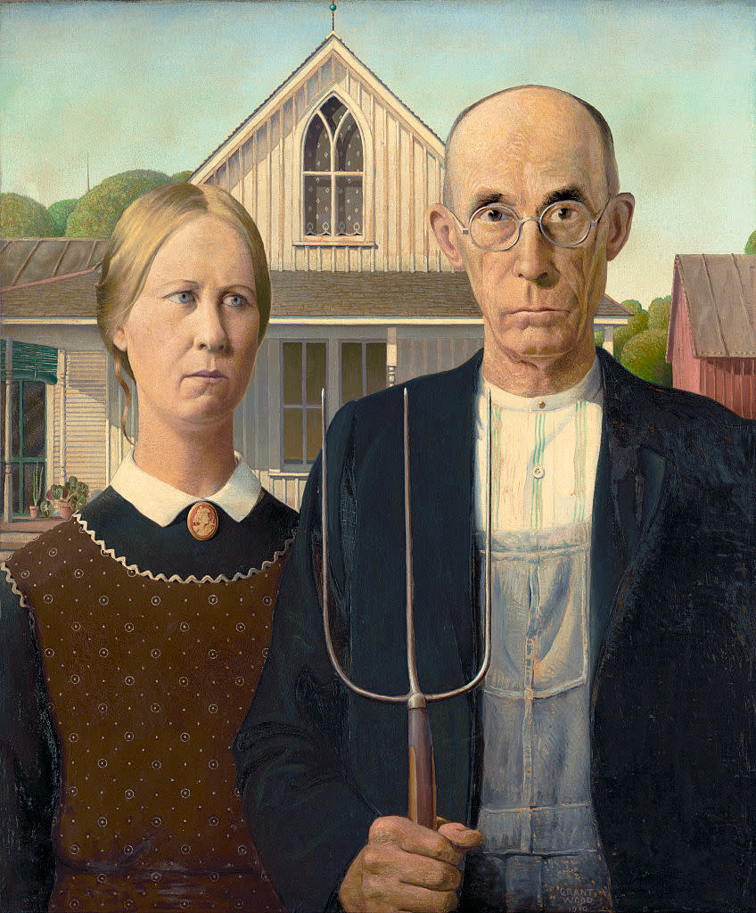 "American Gothic," showing the stern woman and man, who's holding a pitchfork