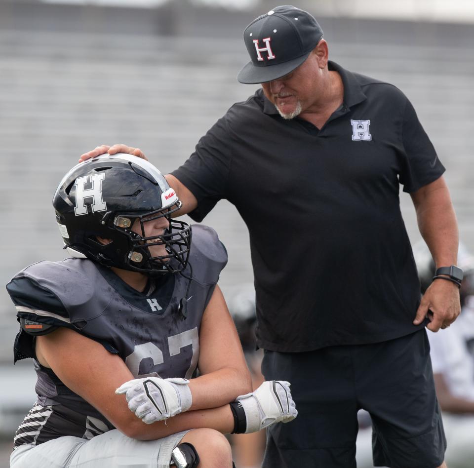 Houston High School offensive lineman Luke Needham speaks with coaching staff member Collins Day during practice Tuesday, Aug. 23, 2022, in Germantown. Needham is a four-year starter for Houston and is now committed to Rice University. 