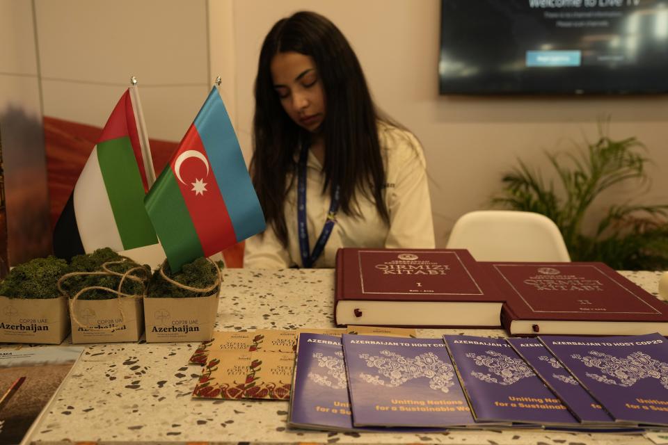 Pamphlets that read Azerbaijan to host COP29 sit at the Azerbaijan Pavilion at the COP28 U.N. Climate Summit, Friday, Dec. 8, 2023, in Dubai, United Arab Emirates. (AP Photo/Rafiq Maqbool)