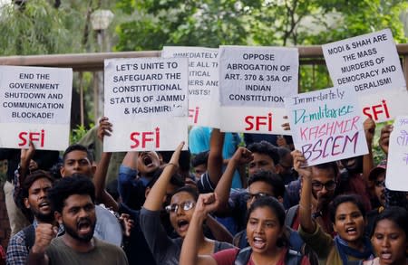 Students display placards and shout slogans during a protest against the scrapping of the special constitutional status for Kashmir by the government, in New Delhi