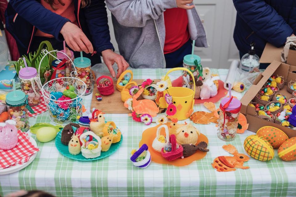 table at an easter yard sale in a garden in the north east of england there are hand made easter crafts on a table and chocolate snacks