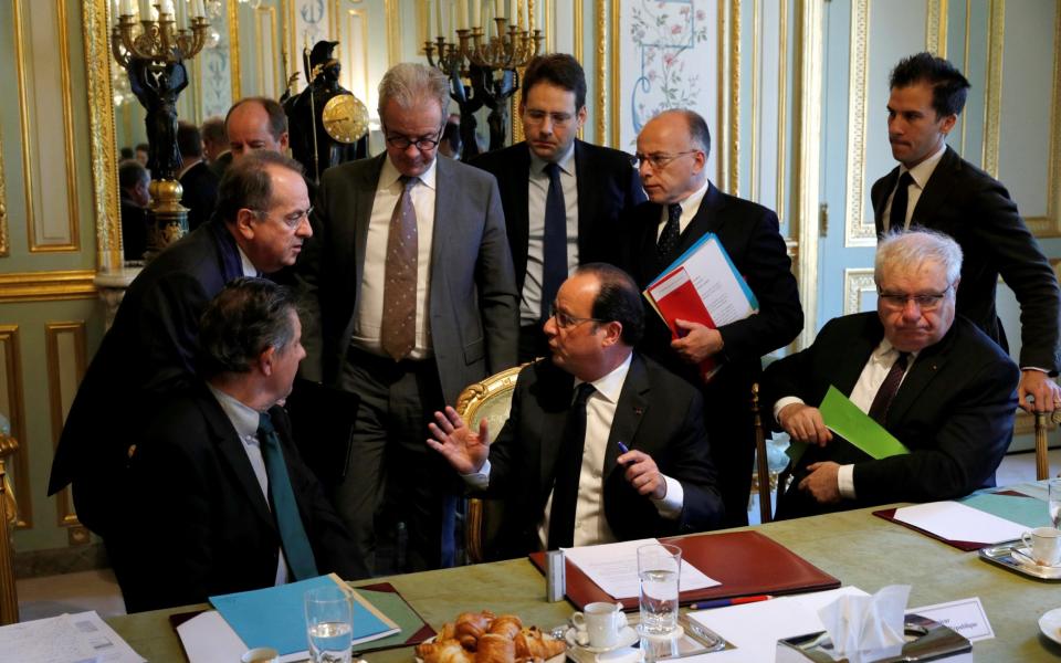 French President Francois Hollande (C) speaks with ministers and officials at the end of a defence council at the Elysee Palace - Credit: REUTERS/Philippe Wojazer