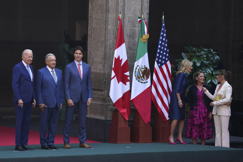 U.S. President Joe Biden, left, Mexican President Andrés Manuel López Obrador, second from left, and Canada's Prime Minister Justin Trudeau pose for an official photo as their wives stand to the side, before the start of a North America Summit at the National Palace in Mexico City, Tuesday, Jan. 10, 2023. The first ladies are, from left, Jill Biden, Beatriz Gutiérrez Müller and Sophie Grégoire Trudeau. (AP Photo/Fernando Llano)