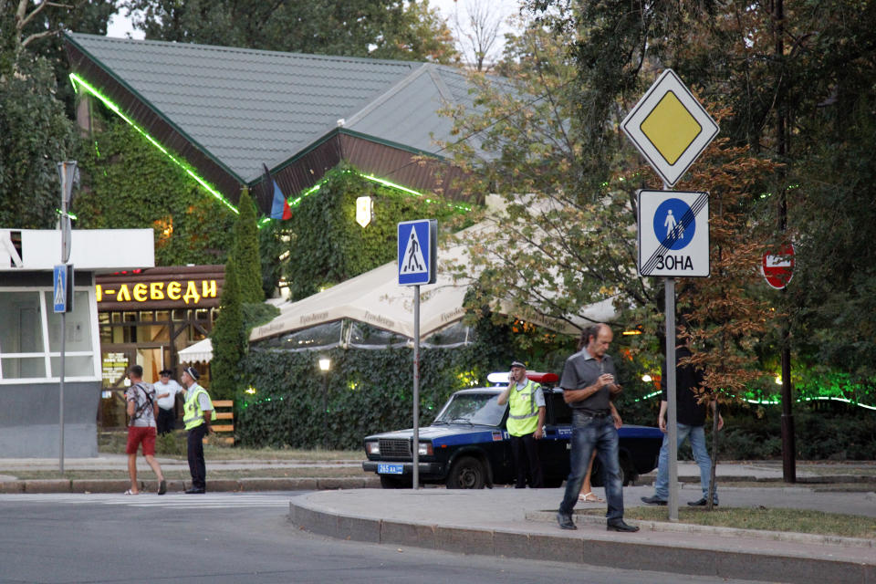 Policemen block traffic close to the site of the murder of rebel leader Alexander Zakharchenko in Donetsk, Ukraine, Friday, Aug. 31, 2018. The news agency of the Russia-backed separatists fighting in eastern Ukraine's Donetsk region is reporting that Zakharchenko has died in an explosion which tore through a cafe in Donetsk, the region's principal city. (AP Photo/Alexander Yermochenko)