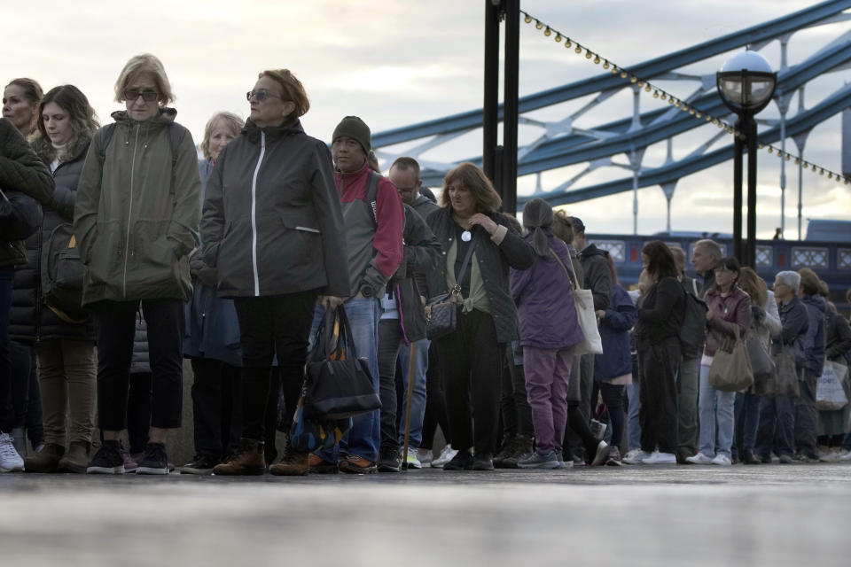 People queue near London Bridge to pay their respects to late Queen Elizabeth II during the Lying-in State, at Westminster Hall in London, Friday, Sept. 16, 2022. The Queen will lie in state in Westminster Hall for four full days before her funeral on Monday Sept. 19. (AP Photo/Christophe Ena)