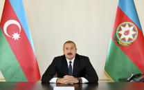 In this photo provided by the Azerbaijan's Presidential Press Office provided on Sunday, Sept. 27, 2020, Azerbaijani President Ilham Aliyev addresses the nation in Baku, Azerbaijan. Fighting between Armenia and Azerbaijan broke out Sunday around the separatist region of Nagorno-Karabakh and the Armenian Defense Ministry said two Azerbaijani helicopters were shot down. Ministry spokeswoman Shushan Stepanyan also said Armenian forces hit three Azerbaijani tanks. (Azerbaijani Presidential Press Office via AP)