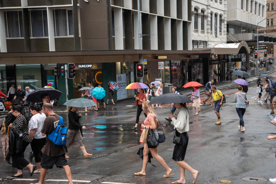 BRISBANE, AUSTRALIA - 2020/02/12: Pedestrians shelter from the rain beneath an umbrella on a rainy day in Brisbane. Severe storm hits South East Queensland and Brisbane CBD causing traffic chaos and floods. (Photo by Florent Rols/SOPA Images/LightRocket via Getty Images)