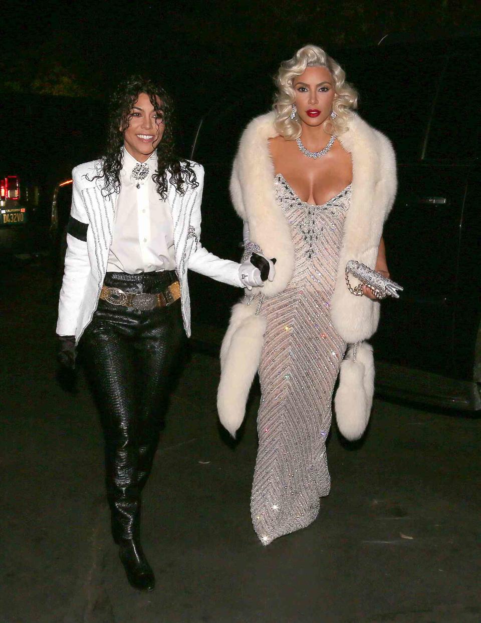 EXCLUSIVE: Kim Kardashian and Kourtney Kardashian are all smiles as they hold each other close as Michael Jackson and Madonna throwback for Halloween weekend