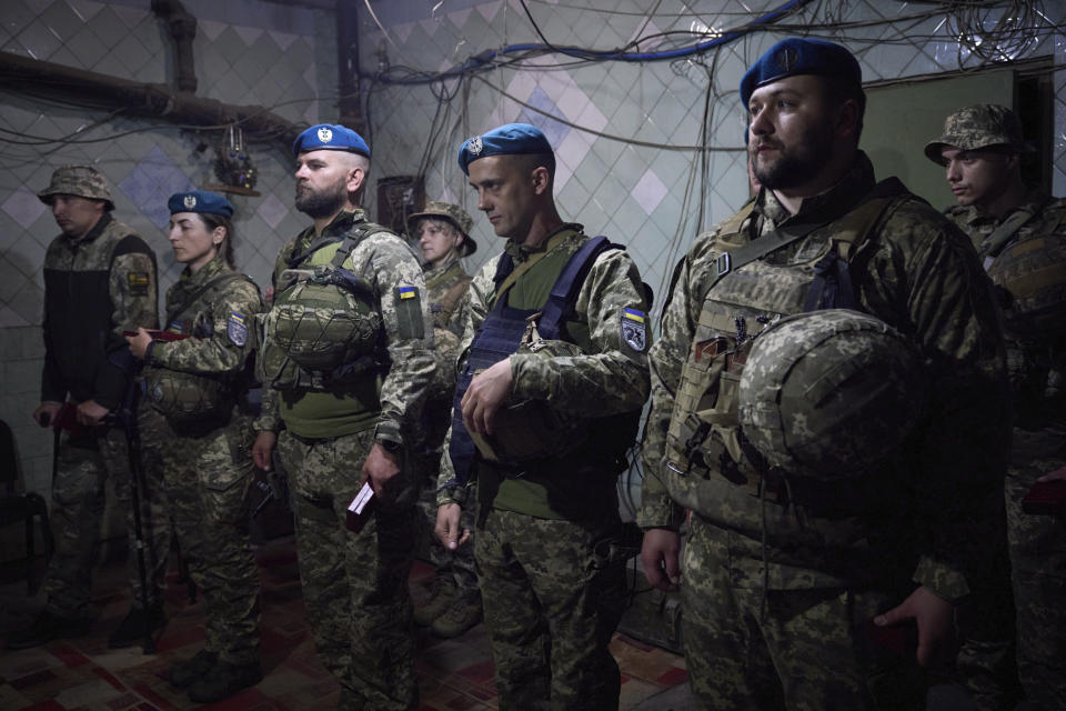 In this photo provided by the Ukrainian Presidential Press Office, Ukrainian soldiers line up as they attend an awarding ceremony during Ukrainian president Volodymyr Zelenskyy's visit to the Donetsk region, Ukraine, Tuesday, May 23, 2023. (Ukrainian Presidential Press Office via AP)