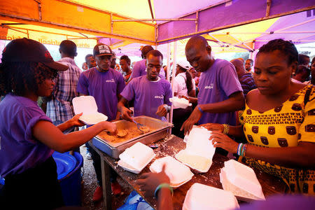 A non-governmental organisation (NGO) serves meals to victims of the mudslide at the internally displaced persons camp in Regent, Sierra Leone August 19, 2017. Picture taken August 19, 2017. REUTERS/Afolabi Sotunde